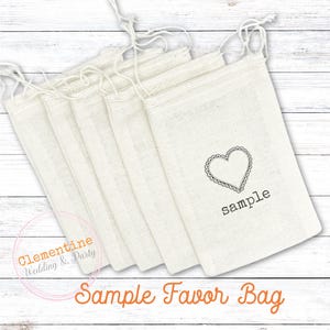 May include: A stack of six white cotton drawstring bags with a heart design and the word "sample" printed on the front.