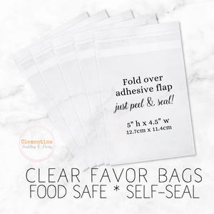 5 clear favor bags are fanned out on a white marble background.  Overlay text:  “CLEAR FAVOR BAGS * FOOD SAFE * SELF SEAL, 5”h x 4.5”w, 12.7cm x 11.4cm. Fold over adhesive flap - just peel and seal!”