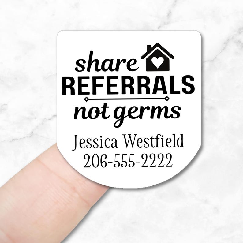 White round sticker with black text that reads "share referrals not germs". A house with a heart inside is above the text. Below the text is "Jessica Westfield" and "206-555-2222".