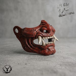 May include: A red, textured samurai-style facial mask featuring prominent white fangs and a weathered finish. The mask includes circular side attachments and the text "stl file dijital dowland" is visible in the upper right corner of the image.