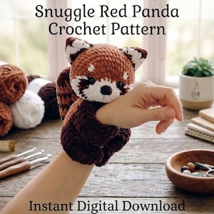 May include: A crochet red panda toy with brown, white, and black yarn, featuring a round head, pointed ears, and a dark nose. The text Snuggle Red Panda Crochet Pattern and Instant Digital Download is displayed above and below the toy.