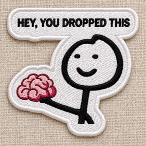May include: An embroidered patch featuring a black stick figure holding a pink brain. Above the figure, a white speech bubble contains the black text HEY, YOU DROPPED THIS. The entire design is outlined in white thread on a textured fabric.