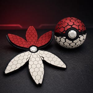 May include: A spherical object with a red and white hexagonal pattern and a central button, alongside a matching flat, five-petaled flower-shaped object featuring the same red and white hexagonal tile design with black borders and a central white button.