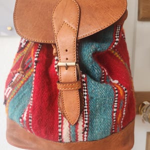 Leather backpack with antique woved material