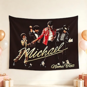 May include: A black rectangular wall tapestry featuring four figures of Michael Jackson in various outfits, including a red jacket and a black suit. The gold cursive text reads Michael and Name Text, set against a dark background with balloons.