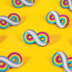 May include: A collection of metal enamel pins shaped like infinity symbols. Each pin features a repeating pattern of stripes in pink, yellow, blue, and white colors, arranged in a continuous loop design with a smooth, polished finish.