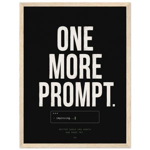 May include: A framed wall art print featuring a black background with the white text ONE MORE PROMPT. Below this, a small box displays the text > improving... followed by the smaller text BETTER IDEAS ARE WORTH ONE MORE TRY and a code bracket icon.
