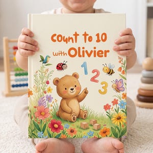 May include: A hardback children's book titled Count to 10 with Olivier, featuring a brown bear illustration, colourful flowers, a ladybird, a bee, a butterfly, and the numbers 1, 2, and 3 printed on a cream-coloured background cover.