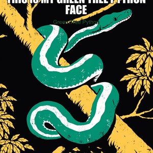 May include: A graphic illustration of a green snake with a white stripe coiled around a yellow tree branch against a black background. The text reads THIS IS MY GREEN TREE PYTHON FACE and Green Tree Python in white and green lettering.
