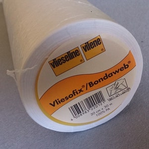 May include: A roll of white Vliesofix/Bondaweb fusible interfacing with the brand name and product information printed on a yellow label. The label includes the text "Vliesofix/Bondaweb", "Vlieseline vilene", and "100% PA".