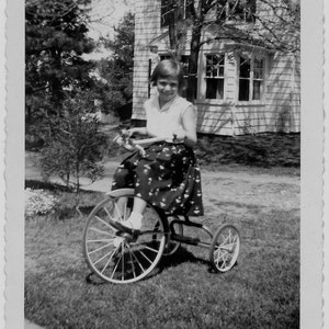 Old Photo Girl on Tricycle wearing Skirt and Sleeveless Shirt 1950s Photograph Snapshot Vintage