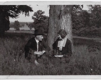 Old Photo Man and Woman sitting in Field by Tree 1910s Photograph Snapshot vintage