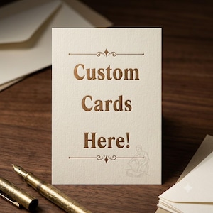 May include: A rectangular off-white card with a textured surface featuring the metallic bronze text Custom Cards Here! centered between two decorative horizontal lines. A small faint illustration of a person is visible in the bottom right corner.