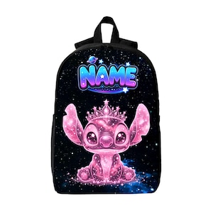 May include: A black backpack featuring a galaxy-themed print with a pink, glowing, starry character wearing a crown. Above the character, the word NAME is printed in a blue and purple gradient font. The design includes small stars and planets.