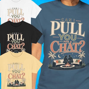 May include: A collection of short-sleeved t-shirts in white, black, yellow, and blue. Each shirt features the text "CAN I PULL YOU FOR A CHAT?" above an illustration of two people sitting on a curved sofa by a fire pit with palm trees.