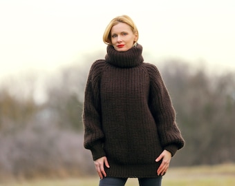 May include: A brown turtleneck sweater with a chunky knit texture. The sweater has a relaxed fit and long sleeves.