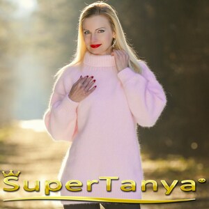 May include: A soft, pink, fuzzy sweater with a high turtleneck. The sweater is made of mohair and has a loose fit.