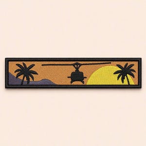 May include: A rectangular embroidered patch featuring a black silhouette of a helicopter flying over a landscape with two palm trees, a purple mountain range on the left, and a large yellow sun on the right, all bordered by a thick black frame.