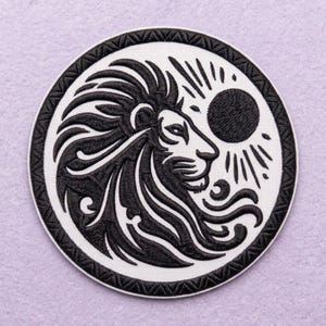 May include: A circular embroidered patch featuring a black lion head profile on a white background. The lion has a flowing mane and is positioned next to a solid black sun with radiating lines. The patch has a thick black border with a geometric pattern.