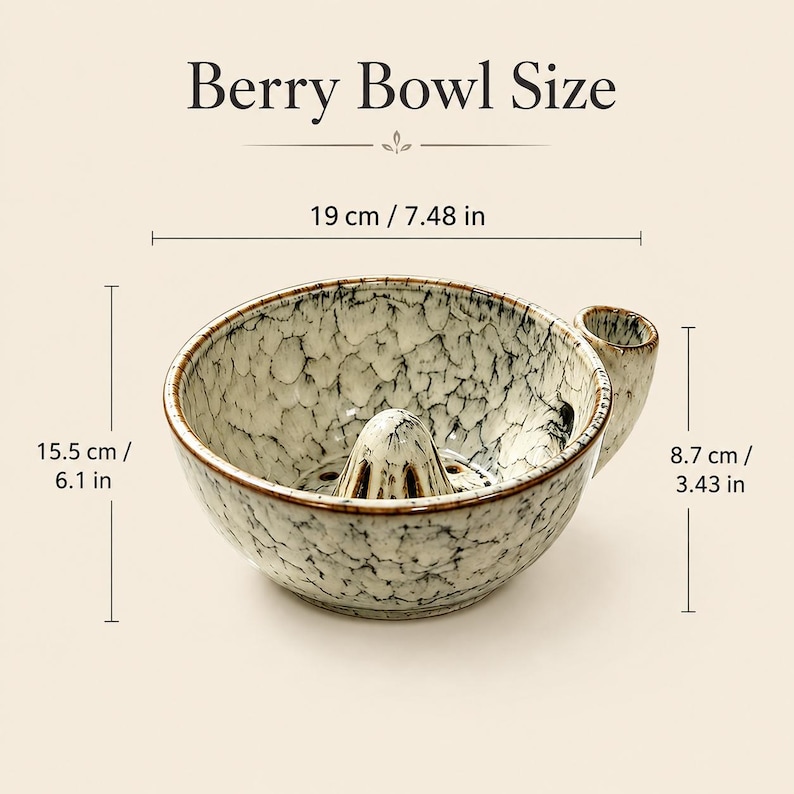 May include: A ceramic berry bowl with a speckled cream and brown glaze, featuring a central cone and a side handle. Text reads Berry Bowl Size. Dimensions are 7.48 inches wide, 6.1 inches deep, and 3.43 inches high, as indicated by the labels.