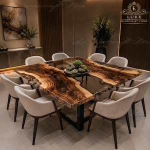 May include: A square dining table featuring a live-edge wood slab with a dark, swirling grain pattern integrated with a central clear resin section. The table is supported by a black metal frame and surrounded by eight light grey upholstered chairs.