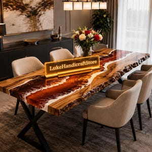May include: A rectangular dining table featuring a natural live-edge wood slab with a central river design made of deep red and white resin. The table has black metal X-shaped legs and a glowing rectangular sign that reads LukeHandicraftStore.