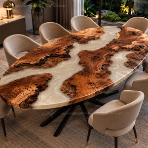 May include: An oval dining table featuring a natural wood slab with a prominent burl grain pattern and a central river-like inlay of translucent white resin. The table is supported by a black metal base and surrounded by eight beige upholstered chairs.