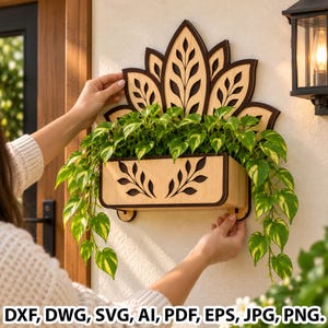 May include: A wall-mounted wooden planter featuring a decorative lotus-shaped back panel with dark brown edges and light wood grain. The rectangular planter box displays a cutout leaf pattern and holds a trailing green and yellow pothos plant.