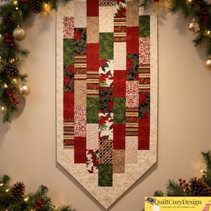 May include: A vertical quilted wall hanging featuring a patchwork design of rectangular fabric strips in red, green, cream, and gold. The fabric patterns include poinsettias, holly, and damask prints. The bottom edge is pointed with a cream border.