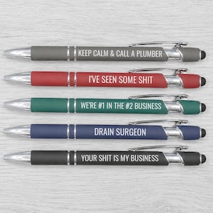 May include: A set of five retractable ballpoint pens with stylus tips. The pens are gray, red, green, blue, and black, each featuring white text: KEEP CALM & CALL A PLUMBER, I'VE SEEN SOME SHIT, WE'RE #1 IN THE #2 BUSINESS, DRAIN SURGEON, and YOUR SHIT IS MY BUSINESS.