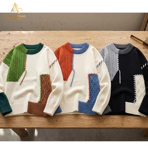 May include: Three long-sleeve crewneck sweaters featuring color-blocked panels in green, orange, and black. Each sweater has cream-colored sections, cable-knit textures, and decorative white lacing details along the seams with ribbed cuffs and hems.