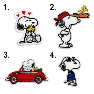 May include: Four embroidered patches featuring Snoopy and Woodstock. Patch 1 shows Snoopy hugging Woodstock with red hearts. Patch 2 shows Snoopy with a red bandana and telescope. Patch 3 shows Snoopy driving a red car. Patch 4 shows Snoopy in sunglasses.