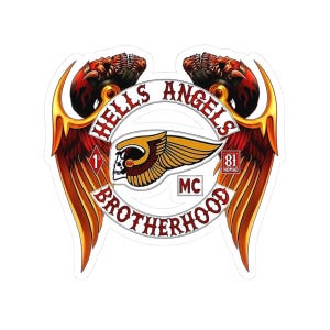 May include: A die-cut sticker featuring the Hells Angels Brotherhood emblem with red and gold wings, two skulls, and a central winged skull logo. The text reads Hells Angels Brotherhood, 1%, 81 Nomad, and MC, with the number 666 on the skull.