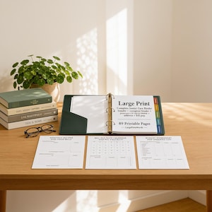 May include: A dark green three-ring binder containing white pages with the text Large Print Complete Senior Care Binder, 89 Printable Pages. Three separate white printed worksheets are laid out in front of the open binder on a wooden surface.