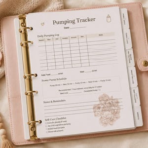 May include: A light pink six-ring binder containing a Pumping Tracker page with sections for a daily pumping log, power pump schedule, notes, and a self-care checklist. The page features a floral illustration and gold-coloured metal rings.