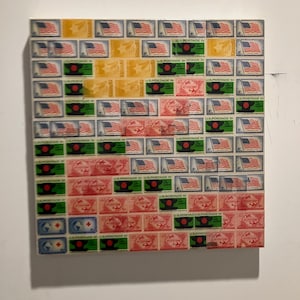 May include: A rectangular artwork composed of vintage postage stamps. The stamps feature the American flag, airplanes, and other designs in red, green, yellow, and blue. The artwork is mounted on a white background.