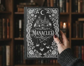 Libro ilustrado de coleccionista de Manacled en tapa dura: edición completa con láminas y marcapáginas.