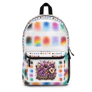 May include: A white backpack featuring a repeating pattern of colorful, blurred rectangular paint swatches. The front pocket displays a detailed illustration of purple and gold flowers with the text Isaiah 54:17 written in a decorative script font.