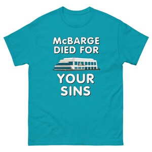 May include: A turquoise blue t-shirt with the text "Mcbarge Died For Your Sins" in white. A white cartoon image of a boat is below the text.