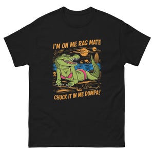 May include: Black t-shirt with a green alligator wearing a pink bikini and sunglasses. The text "I'm on me rag mate chuck it in me dumpa!" is printed on the shirt.