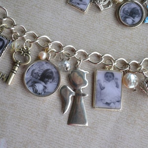 May include: A silver charm bracelet featuring a variety of charms, including a key, a crown, a heart inscribed with the word "LOVE", and several photo charms. The photo charms display black and white images of children.