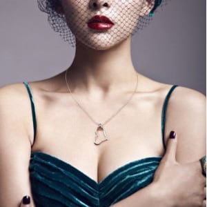 May include: A silver necklace with a heart-shaped pendant. The pendant is open and has a delicate design.