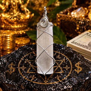 May include: A vertical, rectangular selenite crystal pendant wrapped in silver-toned wire. The wire forms a spiral at the top and a crisscross pattern around the translucent white stone. The pendant is positioned upright on a black surface.