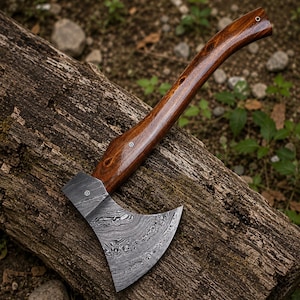 May include: A hand axe featuring a curved, polished dark brown wooden handle with a visible grain and a metal head displaying a distinct, swirling Damascus steel pattern. The axe head is secured to the handle with a small, circular metal rivet.