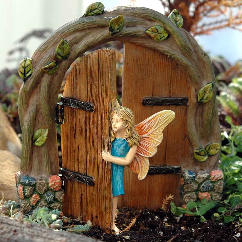 fairy peeking out of a fairy door