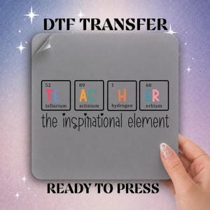 May include: A square DTF transfer sheet featuring a periodic table design that spells TEACHER using chemical elements: Tellurium, Actinium, Hydrogen, and Erbium. Below the boxes, the text reads the inspirational element in black script.