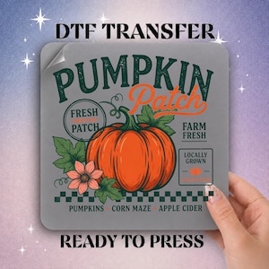 May include: A square DTF transfer sheet featuring a central orange pumpkin with green leaves and a pink flower. The design includes the text PUMPKIN PATCH, FRESH FROM THE PATCH, FARM FRESH, LOCALLY GROWN, PUMPKINS, CORN MAZE, and APPLE CIDER.