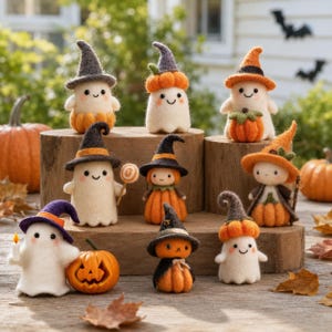 May include: A collection of needle-felted Halloween figures including ghosts and pumpkin-themed characters wearing pointed hats. The figures feature small black eyes, stitched smiles, and orange pumpkin accents, arranged on wooden blocks.