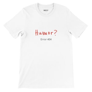 May include: A white short-sleeved t-shirt featuring the red handwritten-style text Humor? followed by the black printed text Error 404. The inner collar label displays the brand name FINNTEES in black text on a white background.