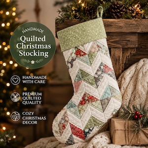 May include: A quilted Christmas stocking featuring a chevron pattern of red, green, and white fabric patches. It has a solid light green cuff with a small white star print and a fabric loop for hanging. The text reads Handmade Quilted Christmas Stocking.